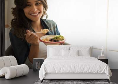 Woman eating a vegan bowl Wall mural