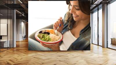 Woman eating a vegan bowl Wall mural