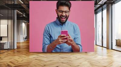 Happy 30s Indian man staring at mobile phone screen celebrate success, get bonus or money refund, reading about lottery victory, receive great news in message, make yes gesture feels overjoyed Wall mural