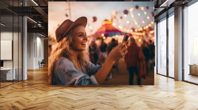 Young woman taking pictures from smartphone at music festival Wall mural