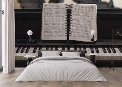 Shallow focus shot of a piano with a songbook Wall mural