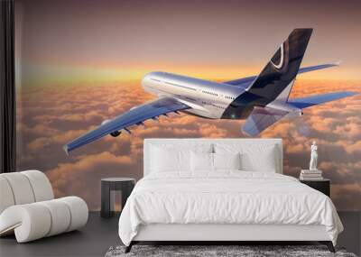 Jet flying over cloudscape at sunset Wall mural