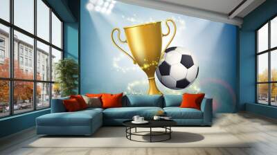 Soccer ball with the golden cup of championship. Wall mural