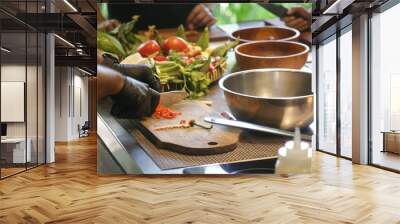 Adult students learning recipe and preparing meal in cooking class Wall mural