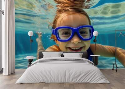 Child wearing swimming goggles and enjoying hot summer day in the swimming pool Wall mural