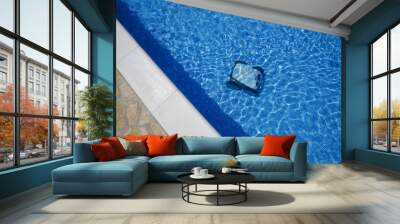 Cleaning the pool floor with an underwater vacuum cleaner, pool maintenance concept. Wall mural