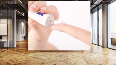 Close up image of hands with cream tube Wall mural