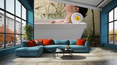 Portrait of a young woman relaxing in the bathtub, organic skin-care at the luxury hotel spa, wellbeing and self-care concept Wall mural