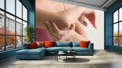 Woman showing dry itchy skin on the elbow area  Wall mural