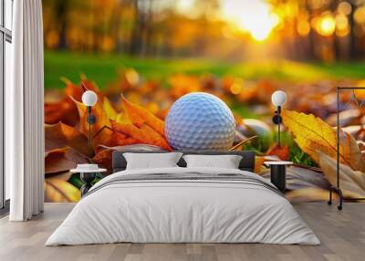 Golf ball resting on autumn greens surrounded by fallen leaves, serene beauty of nature Wall mural