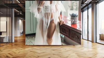 Luxury stylish bride in boudoir lace dress and looking at the window Wall mural