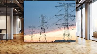 group silhouette of transmission towers (power tower, electricity pylon, steel lattice tower) at sun Wall mural