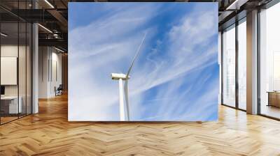 Low angle, close-up view a wind turbine tower again cloud blue sky on a wind farm at Ellensburg, Washington, US. Clean, sustainable, renewable energy concept. Alternative energy source from wind power Wall mural