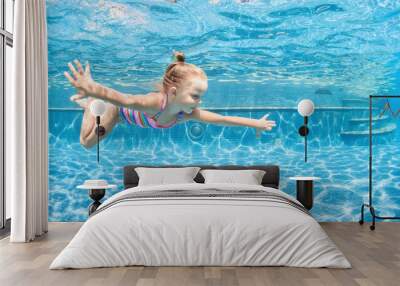 Funny portrait of child learning swimming, dive in blue pool with fun - jumping deep down underwater with splashes. Healthy family lifestyle, kids water sports activity, swimming lesson with parents. Wall mural