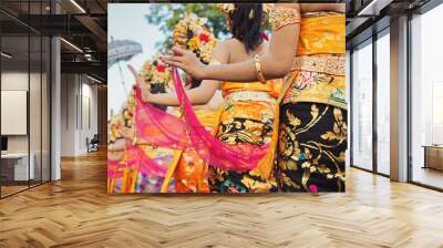 Group of beautiful Balinese girls in bright traditional costumes - sarongs decorated by hindu Barong and Garuda masks. Arts and culture of Bali island and Indonesia people and asian travel backgrounds Wall mural