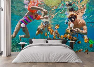 Happy family - father, mother, child in snorkeling mask dive underwater with tropical fishes in coral reef sea pool. Travel lifestyle, water sport adventure, swimming on summer beach holiday with kids Wall mural