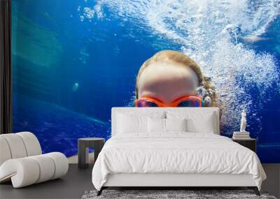 Happy family in swimming pool. Smiling child in goggles swim, dive in pool with fun - jump deep down underwater. Healthy lifestyle, people water sport activity, swimming lessons on holidays with kids Wall mural