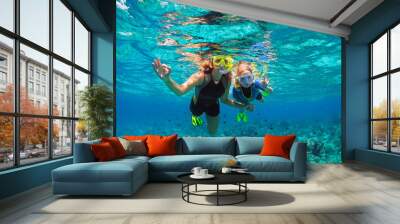 Happy family - mother, kid in snorkeling mask dive underwater with tropical fishes in coral reef sea pool. Show by hands divers sign OK. Travel lifestyle, beach adventure on summer holiday with child. Wall mural