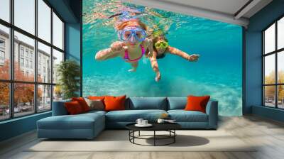 Happy family - mother with baby girl dive underwater with fun in sea pool. Healthy lifestyle, active parent, people water sport outdoor adventure, swimming lessons on beach summer holidays with child Wall mural