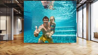 Happy people dive underwater with fun in aqua park swimming pool. Father, daughter show thumbs up. Family lifestyle, kids water sports activity, children swimming lesson with parents on summer holiday Wall mural