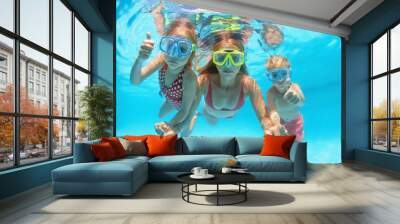 Happy people dive underwater with fun. Funny photo of mother, kids in snorkeling masks in aqua park swimming pool. Family lifestyle, children water sport activity, lesson with parent on summer holiday Wall mural