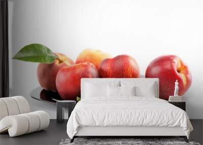 Fresh peaches and nectarines in a basket isolated on a white bac Wall mural