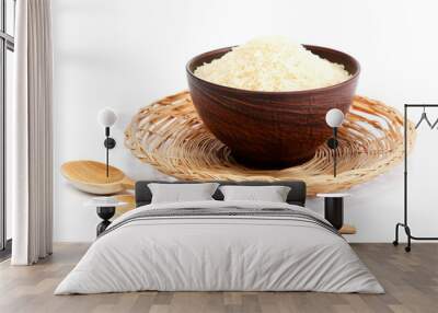 Grains of rice in a bowl and wooden spoon. Wall mural