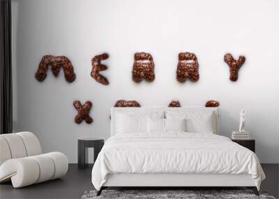 Top view of white milk and chocolate alphabet cereals. Merry xmas text. white background Wall mural