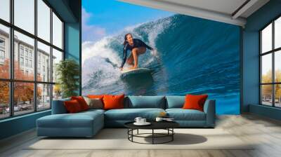 Female surfer on a blue wave Wall mural