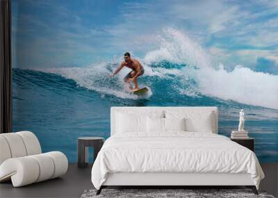 Shirtless male surfer on a wave at sunny day Wall mural