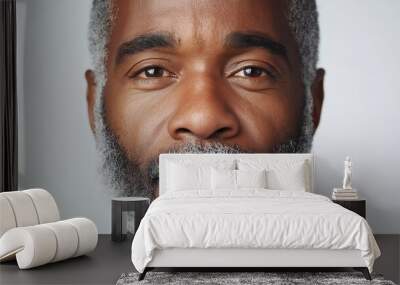 A man with a beard and gray hair is looking at the camera. He has a serious expression on his face Wall mural