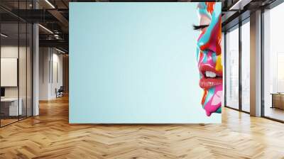 A woman with colorful face paint is the main focus of the image. The background is a light blue color, and the woman's face is painted in a rainbow of colors. Concept of creativity and self-expression Wall mural