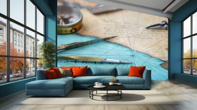 An old geographic map with navigational tools: compass, divider, ruler, protractor. View of the workplace of ship's captain. Travel, geography, navigation, tourism and exploration concept background. Wall mural