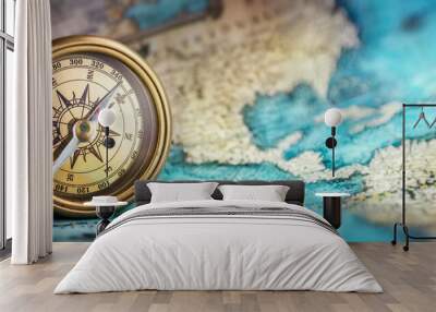 Magnetic old compass on world map.Travel, geography, navigation, tourism and exploration concept background. Macro photo. Very shallow focus. Wall mural