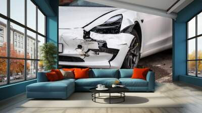 Crashed white electric car waiting for repair. Wall mural