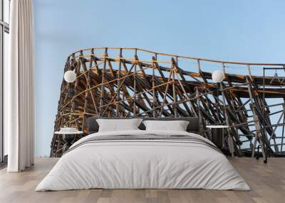 Curve of a large wooden roller coaster. Wall mural