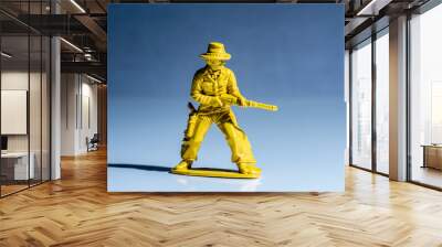 Yellow cowboy plastic toy figure. Wall mural