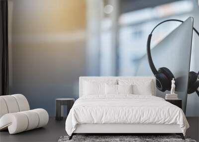 Call center, headset on a computer in an empty office with flare and mockup for communication or assistance. Customer care, support and equipment in a workplace after hours for help or service Wall mural