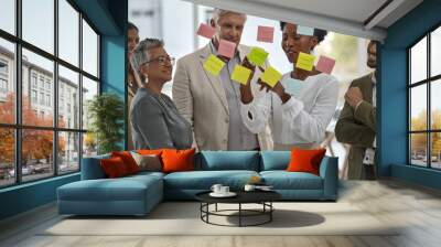 Meeting, presentation and glass with a black woman leading a presentation in a boardroom for company strategy. Teamwork, planning and sticky notes in an office with a female employee talking to staff Wall mural