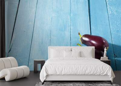 two eggplants with shade on blue wood table Wall mural