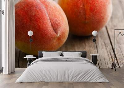 two peach fruits on old weathered wooden table background Wall mural