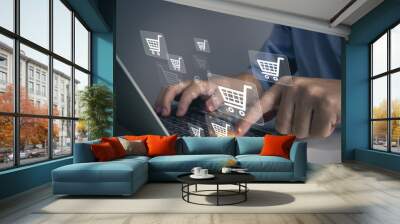 Shopping online icon, e-commerce concept.Man hand using laptop computer with online shopping icon at office.internet banking, spending money, credit card. Wall mural