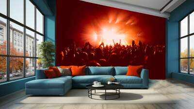 a crowded concert hall with scene stage in red lights, rock show performance, with people silhouette Wall mural