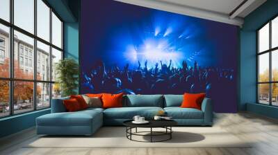 a crowded concert hall with scene stage lights in blue tones, rock show performance, with people sil Wall mural