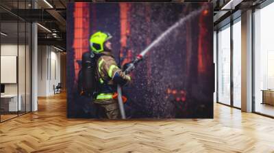 Firefighters put out large massive fire blaze, group of fire men in uniform during fire fighting operation in the city streets, firefighters with the fire engine truck fighting vehicle Wall mural