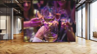 People celebrate and raise glasses, cheering with alcohol glasses with wine and champagne in the restaurant on corporate christmas birthday party event or wedding celebration Wall mural