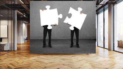 Men holding two puzzles Wall mural