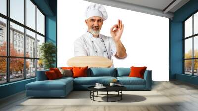 Chef-cooker in a chef's hat and jacket holding an empty wooden tray for mock up. Senior professional baker man wearing a chef's outfit. Character kitchener, pastry chef for advertising Wall mural