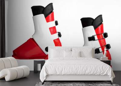 Red and white ski boots with black buckles on isolated background. Wall mural