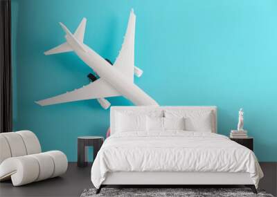 Love travel concept. Miniature plane with heart shaped symbol on bright blue background. Vacation and romance. Wall mural